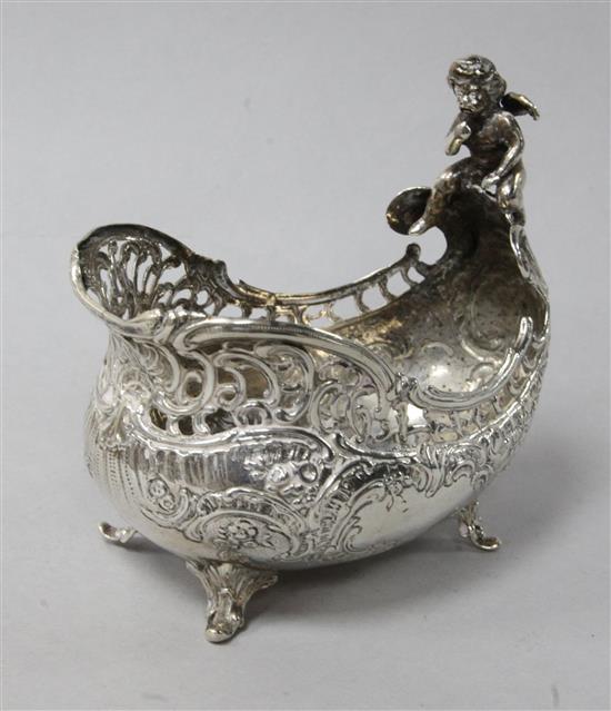An early 20th century German silver boat shaped bowl with cherub surmount, import marks for London, 1903, height 9.7cm.